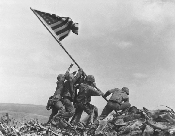 U.S. Marines of the 28th Regiment of the Fifth Division raise the American flag atop Mt. Suribachi, Iwo Jima circa 23 February 1945 (Joe Rosenthal)