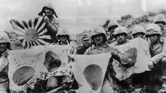 US Marines capture Japanese flags on Pacific Island of Iwo Jima in the War in the Pacific in February 1945